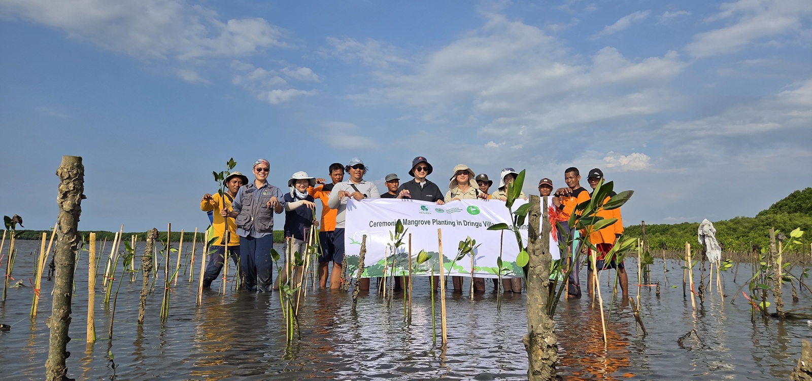 Group with Tarp Banner, low mid-long shot.jpg